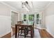 Bright dining area with wainscoting, wood floors and a large window with shutters at 2356 Defoors Ferry Nw Rd, Atlanta, GA 30318