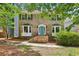 Charming brick two-story home with a bright blue front door and manicured landscaping at 2356 Defoors Ferry Nw Rd, Atlanta, GA 30318