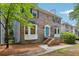 Beautiful two-story brick home featuring a charming blue door and lovely bay windows at 2356 Defoors Ferry Nw Rd, Atlanta, GA 30318