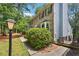 Serene view of a brick home exterior surrounded by mature trees and lush greenery at 2356 Defoors Ferry Nw Rd, Atlanta, GA 30318