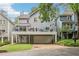 Back exterior view of gray townhouse with a large deck and garage; lush greenery adds to the curb appeal at 2356 Defoors Ferry Nw Rd, Atlanta, GA 30318