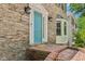 Close-up of an inviting blue front door and brick entrance to the beautiful home at 2356 Defoors Ferry Nw Rd, Atlanta, GA 30318