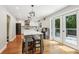 Bright kitchen with white cabinetry, an island with marble countertop, and French doors to the outdoor deck at 2356 Defoors Ferry Nw Rd, Atlanta, GA 30318