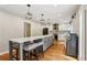 Open kitchen features a long island with seating, modern lighting, and stainless steel appliances at 2356 Defoors Ferry Nw Rd, Atlanta, GA 30318