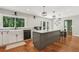 Bright kitchen with white cabinets, a large window, and a central island with seating at 2356 Defoors Ferry Nw Rd, Atlanta, GA 30318