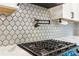 Stylish kitchen backsplash and modern gas range at 2356 Defoors Ferry Nw Rd, Atlanta, GA 30318