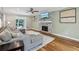 Cozy living room with a decorative fireplace, plush sectional sofa, and hardwood flooring at 2356 Defoors Ferry Nw Rd, Atlanta, GA 30318