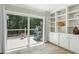 Bright living room featuring built-in shelving, sliding doors to deck and outside grilling area at 2356 Defoors Ferry Nw Rd, Atlanta, GA 30318