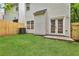 Backyard featuring newly seeded grass and a privacy fence, accessible through glass patio doors at 2849 Windsor Forrest Ct, Atlanta, GA 30349