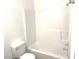 Clean bathroom with a white toilet and tub/shower with white surround at 2849 Windsor Forrest Ct, Atlanta, GA 30349