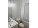 Bright bathroom with a white vanity, granite countertop, and window at 2849 Windsor Forrest Ct, Atlanta, GA 30349