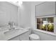 Elegant half-bath featuring a marble countertop and a bright window view at 2849 Windsor Forrest Ct, Atlanta, GA 30349