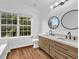 Bright bathroom with double vanity, natural light and modern fixtures at 2849 Windsor Forrest Ct, Atlanta, GA 30349