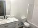 Well-lit bathroom with a clean, updated vanity, sink, and toilet next to shower/tub at 2849 Windsor Forrest Ct, Atlanta, GA 30349