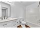 Well-lit bathroom featuring a vanity with marble countertop, framed mirror, and shower-tub combo at 2849 Windsor Forrest Ct, Atlanta, GA 30349