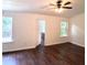 Spacious main bedroom featuring hardwood floors and natural light from two windows at 2849 Windsor Forrest Ct, Atlanta, GA 30349