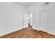 Neutral bedroom showing wood-look flooring and white walls and doors with an open doorway to another room at 2849 Windsor Forrest Ct, Atlanta, GA 30349