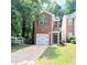 Charming two-story brick home featuring an attached garage and well-maintained front lawn at 2849 Windsor Forrest Ct, Atlanta, GA 30349