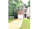 Brick facade home featuring an attached garage, contrasted with lush greenery at 2849 Windsor Forrest Ct, Atlanta, GA 30349
