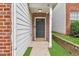 Inviting front entrance with a gray door and a well-maintained small lawn at 2849 Windsor Forrest Ct, Atlanta, GA 30349