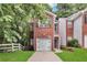 Charming brick home featuring an attached garage and a well-manicured front lawn at 2849 Windsor Forrest Ct, Atlanta, GA 30349