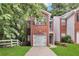 Charming brick home featuring an attached garage and a well-manicured front lawn at 2849 Windsor Forrest Ct, Atlanta, GA 30349
