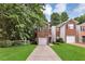 Charming brick home featuring an attached garage and a well-manicured front lawn at 2849 Windsor Forrest Ct, Atlanta, GA 30349