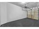 Spacious, empty garage with sleek gray flooring and white walls, ready for parking or storage at 2849 Windsor Forrest Ct, Atlanta, GA 30349