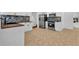 Bright kitchen featuring white cabinetry, stainless appliances, and tile floors at 2849 Windsor Forrest Ct, Atlanta, GA 30349
