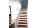 Elegant wooden staircase featuring white risers and handrail at 2849 Windsor Forrest Ct, Atlanta, GA 30349