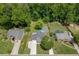 Aerial view of a suburban home with a backyard pool, fire pit, and lush greenery at 2920 Waverly Place Dr, Dacula, GA 30019