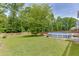 Large lawn with mature trees and pool, offering a private and serene outdoor experience at 2920 Waverly Place Dr, Dacula, GA 30019