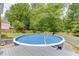 Relaxing above-ground pool in a private backyard surrounded by lush trees and landscaping at 2920 Waverly Place Dr, Dacula, GA 30019