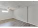 Spacious basement with modern wood flooring, neutral paint, and ceiling fan with light fixture at 2920 Waverly Place Dr, Dacula, GA 30019