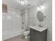 Updated bathroom with tile shower, large vanity with marble counter, and modern light fixtures at 2920 Waverly Place Dr, Dacula, GA 30019