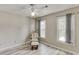 Bedroom with natural light and neutral walls, featuring a rocking chair at 2920 Waverly Place Dr, Dacula, GA 30019