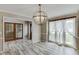 Dining room with chandelier, curtains, wood flooring, and access to other rooms at 2920 Waverly Place Dr, Dacula, GA 30019