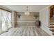 Elegant dining room featuring a chandelier, wainscoting, and modern flooring at 2920 Waverly Place Dr, Dacula, GA 30019