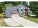Charming brick and siding home with a spacious driveway and a well-manicured lawn at 2920 Waverly Place Dr, Dacula, GA 30019