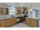 This updated kitchen features granite counters, stainless steel appliances, and warm wood cabinetry at 2920 Waverly Place Dr, Dacula, GA 30019