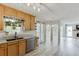 Open kitchen with wood cabinets, granite countertops, stainless steel appliances, and an adjacent living area at 2920 Waverly Place Dr, Dacula, GA 30019