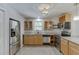 The kitchen features stainless steel appliances, wood cabinets, granite countertops, and tile flooring at 2920 Waverly Place Dr, Dacula, GA 30019