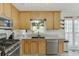 Kitchen with stainless steel appliances, granite countertops, and wood cabinets at 2920 Waverly Place Dr, Dacula, GA 30019