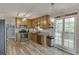 Well-lit kitchen with stainless steel appliances, wooden cabinets, and sliding door to deck at 2920 Waverly Place Dr, Dacula, GA 30019
