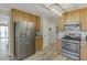 A kitchen with a large stainless steel refrigerator and stove with wood cabinets at 2920 Waverly Place Dr, Dacula, GA 30019