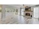 Open living room featuring a brick fireplace, large windows, and light gray flooring at 2920 Waverly Place Dr, Dacula, GA 30019