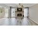 Bright living room boasting a brick fireplace, ceiling fan, and durable gray flooring at 2920 Waverly Place Dr, Dacula, GA 30019