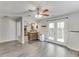 Open-concept living room showcasing wood floors, ceiling fan, and French doors to the backyard at 2920 Waverly Place Dr, Dacula, GA 30019