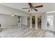 Open living space with stylish gray floors, arched doorways, and a view into the kitchen at 2920 Waverly Place Dr, Dacula, GA 30019