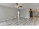 Spacious living room with updated flooring flowing into the kitchen area with black appliances at 2920 Waverly Place Dr, Dacula, GA 30019